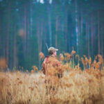hunter standing in field properly dressed for tick prevention